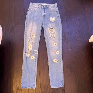 light washed demin jeans with rips and flower patches from chelsea and violet